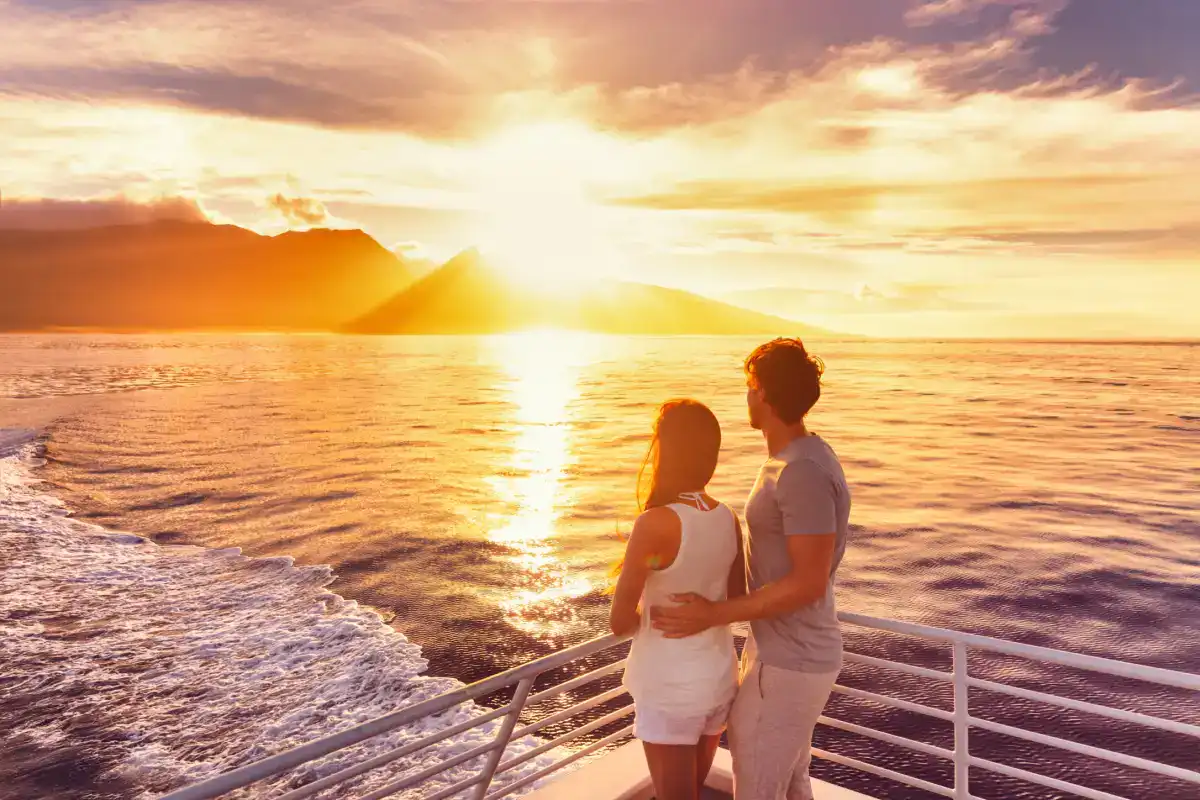 Couple enjoying a romantic moment during Maui sunset dinner cruise near Kahana Village.