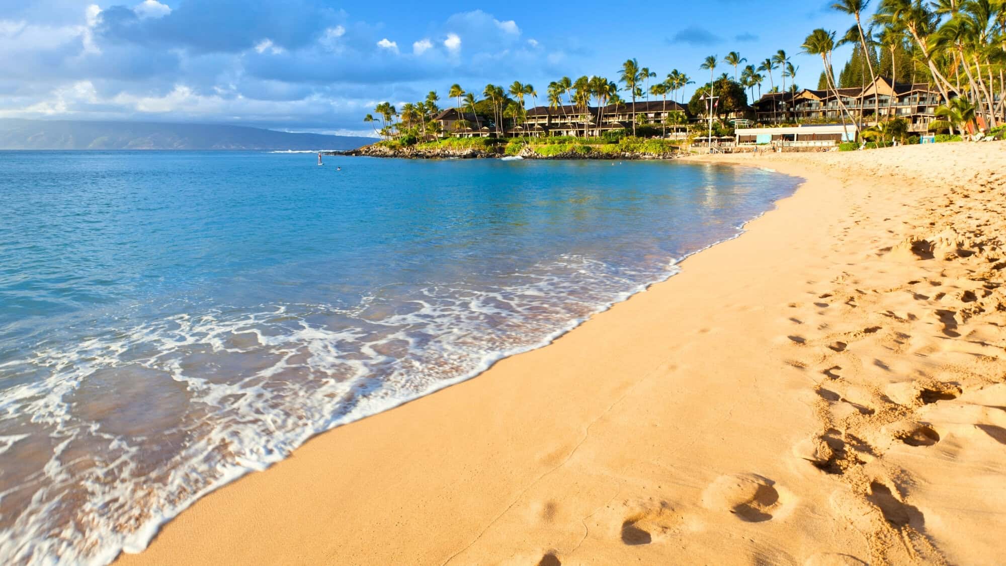 Scenic view of Napili Bay Beach with soft sand and tranquil water.