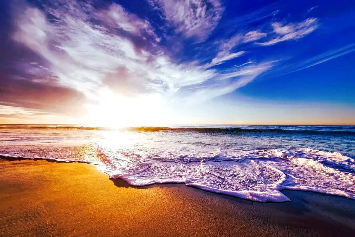 Sunlight glimmers on ocean waves at a serene beach near Kahana Village, ideal for families and couples.