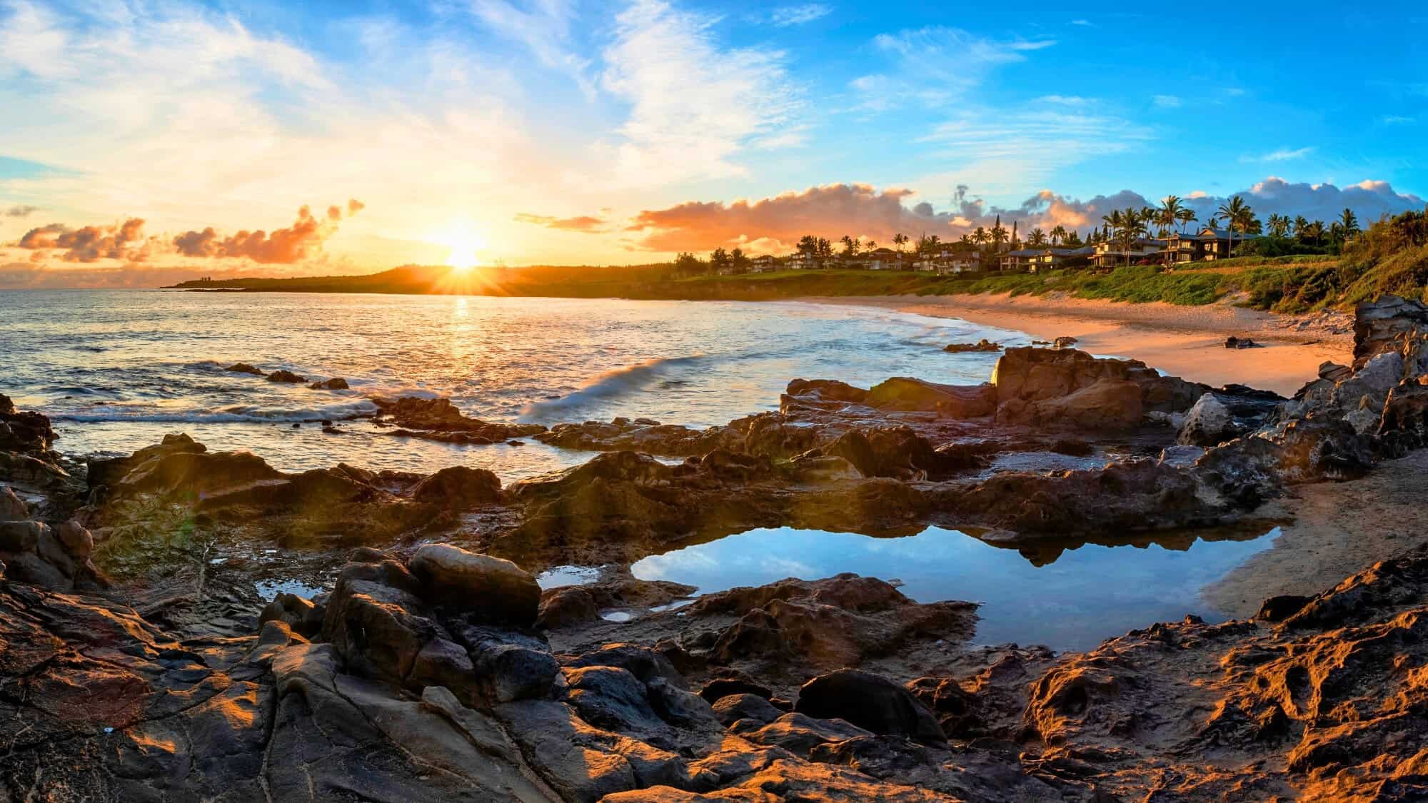Stunning sunset at Kapalua Beach, with brilliant sky colors and gentle waves.