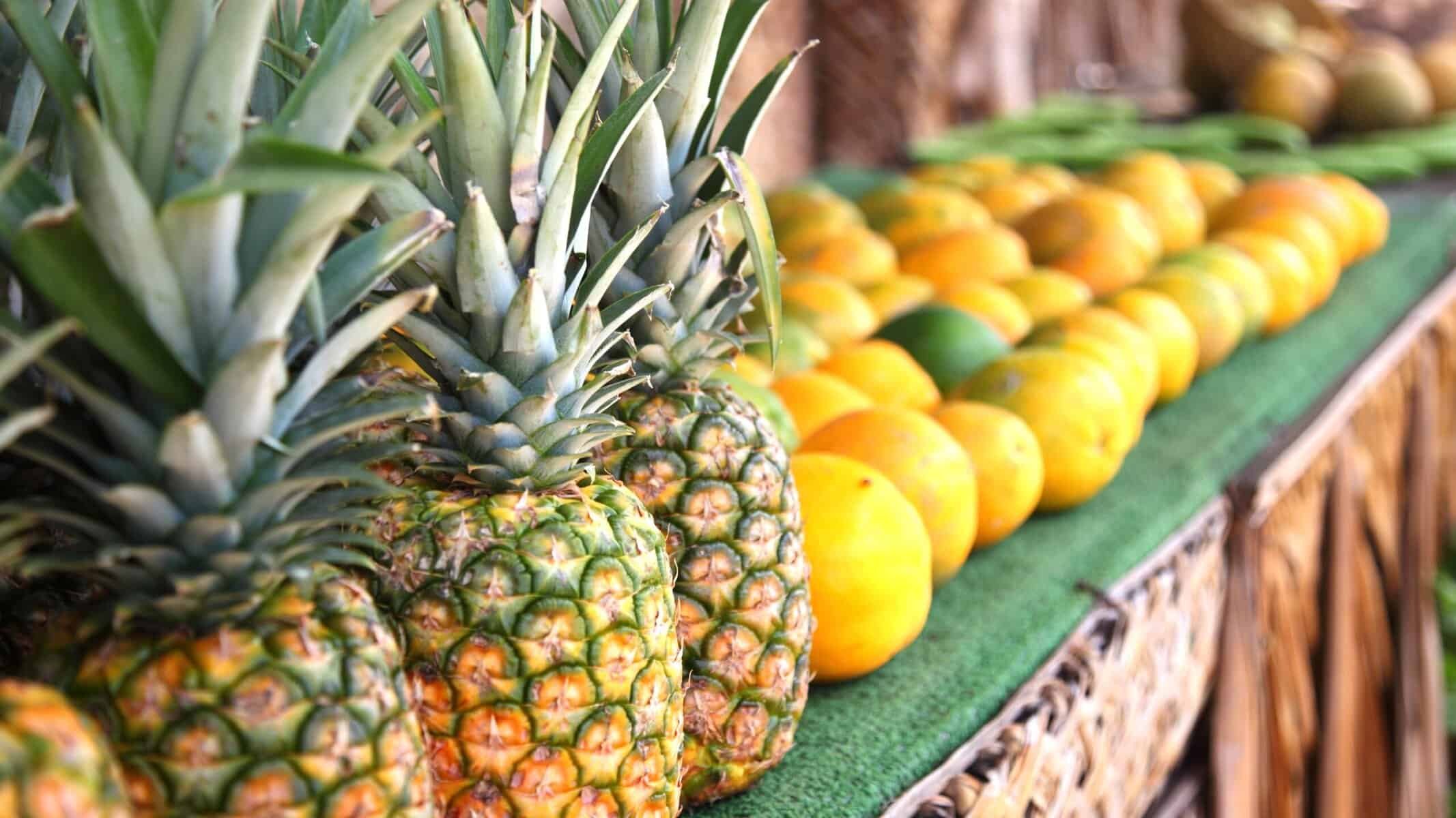 Fresh pineapples & other fruits on display at West Maui's farmers market.