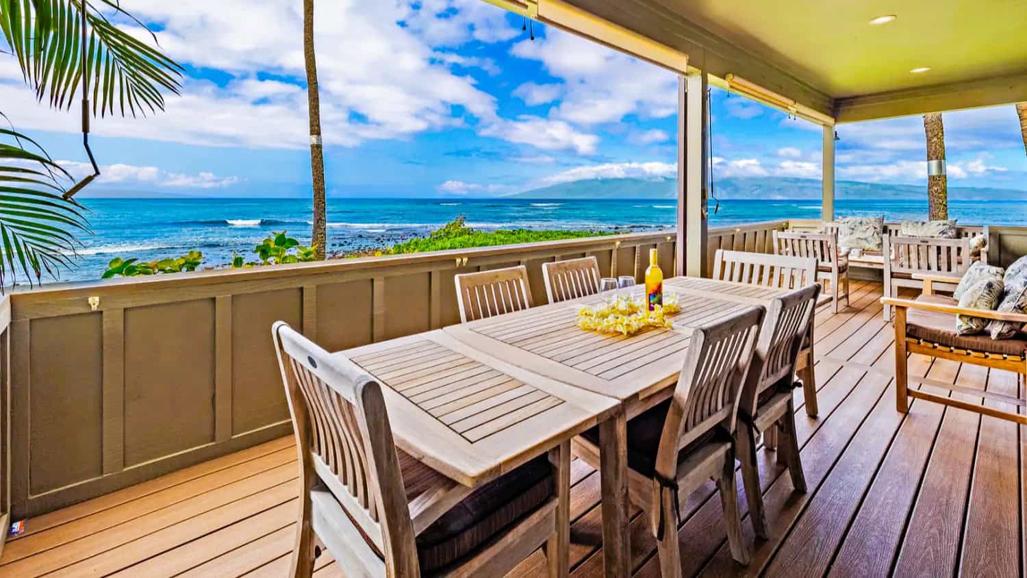 Scenic ocean view from a balcony at Kahana Village, with a table and chairs set on the deck.  