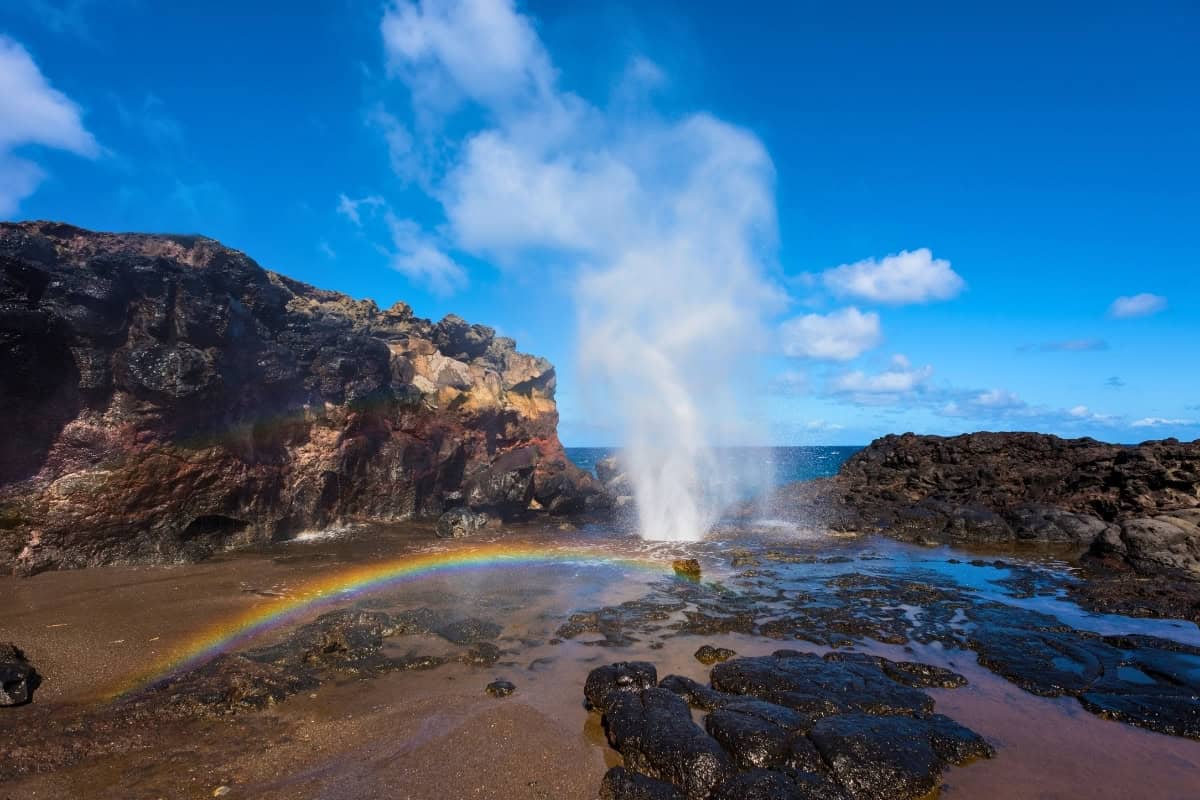 A vibrant rainbow at Nakalele blowhole, creating a stunning natural display on Maui.